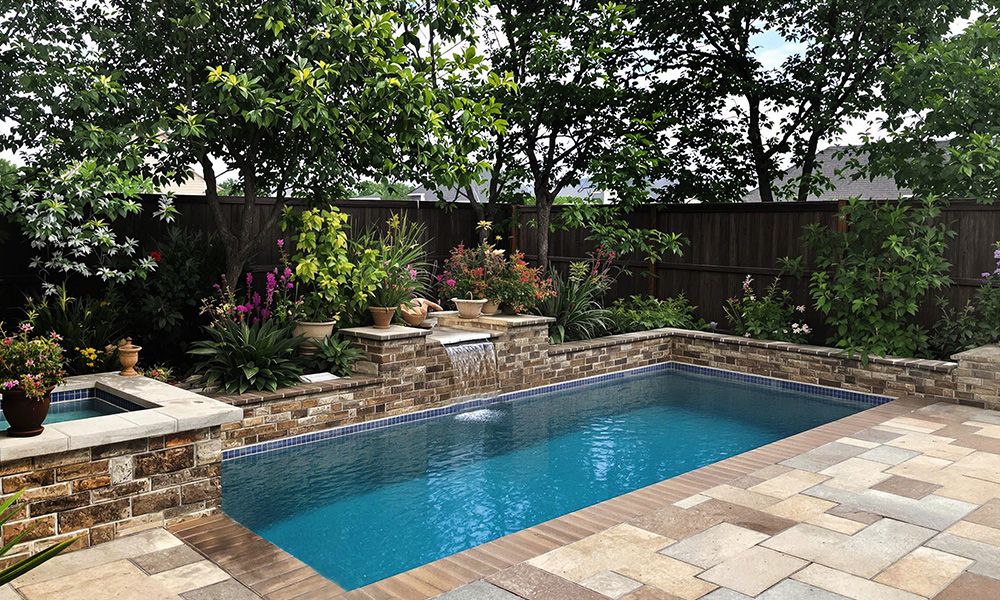 Concrete Swimming Pool with Rockwork backyard